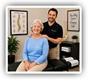 Chiropractor with a smiling senior patient